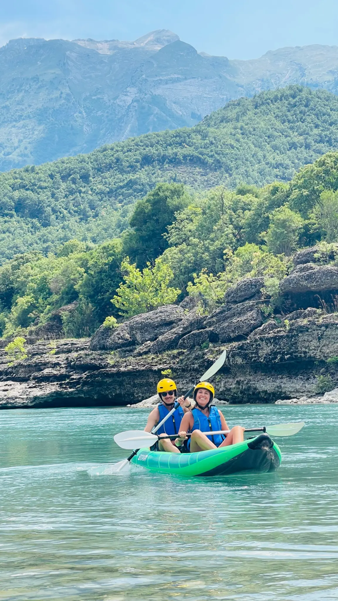 Kayak on the wide, shallow Vjosa riverbed below the mountains near Përmet