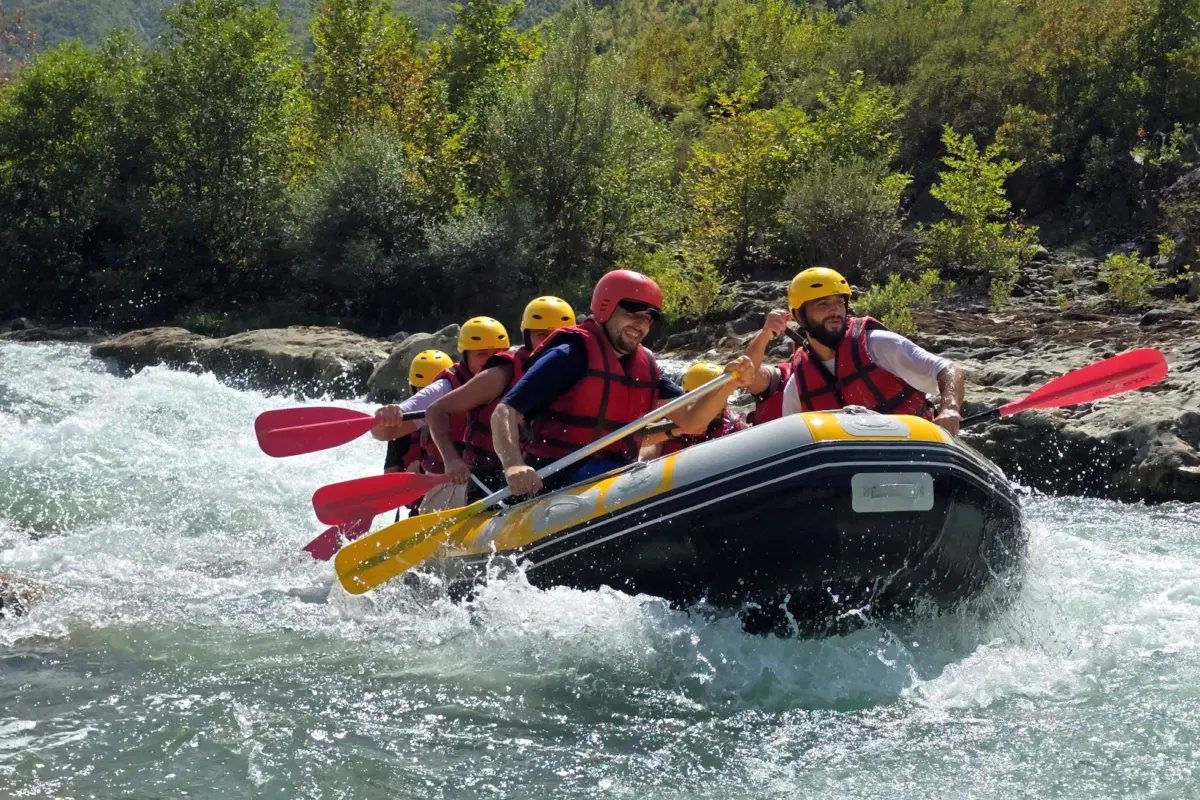 Fotos von der Vjosa 13 Rafting crew in yellow helmets paddling a raft through a rapid on the Vjosa River near Përmet