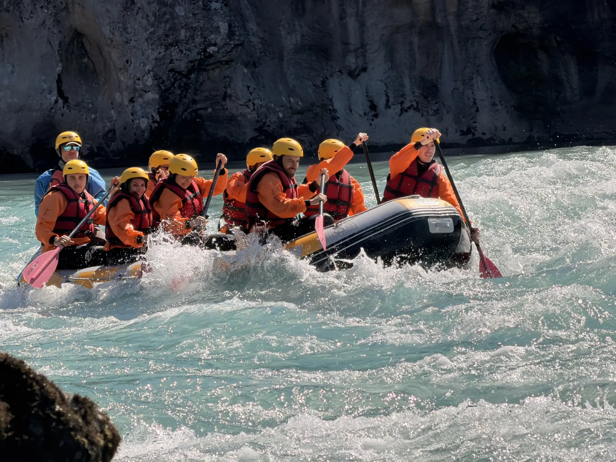 Rafting Vjosa Albania guides steering a full raft through a rapid