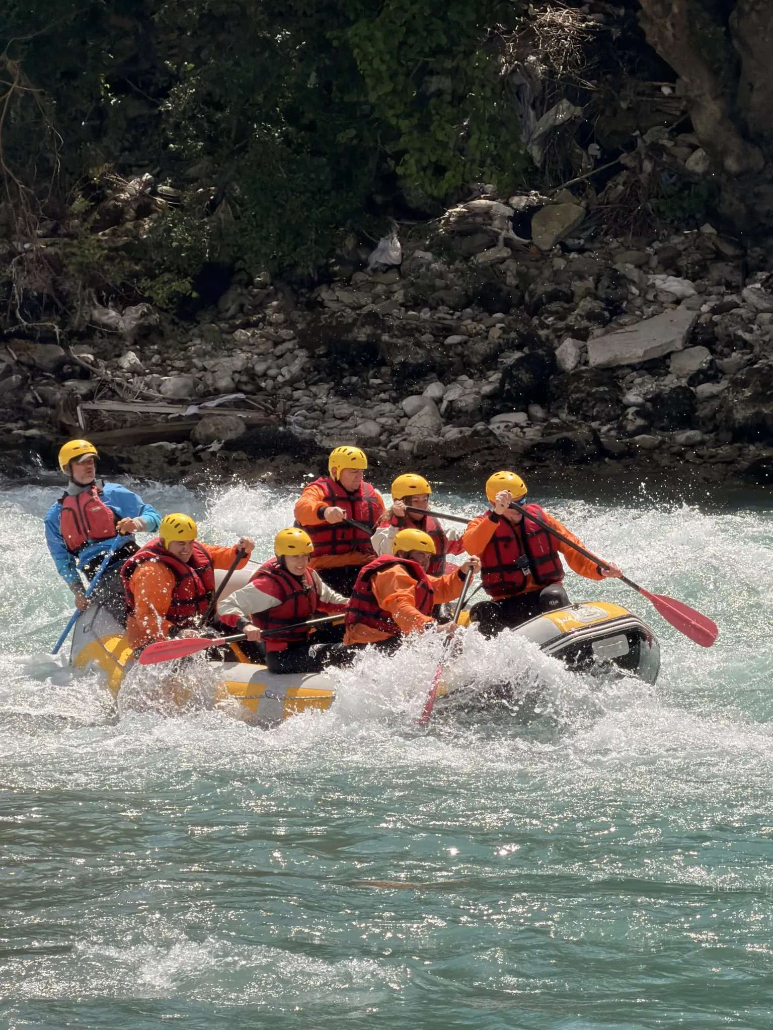 Rafting group holding paddles up after a rapid on the Vjosa