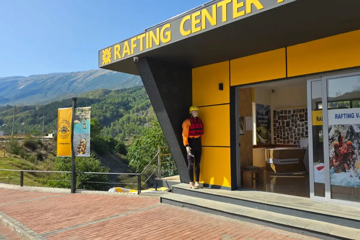 Rafting Vjosa Albania's riverside centre in Përmet with the yellow RAFTING CENTER sign