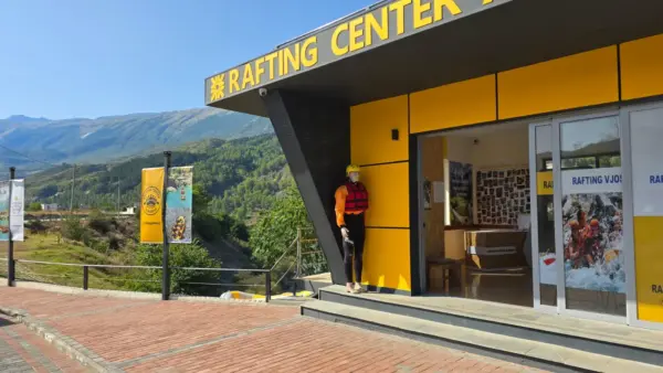 Rafting Vjosa Albania's riverside centre in Përmet with the yellow RAFTING CENTER sign